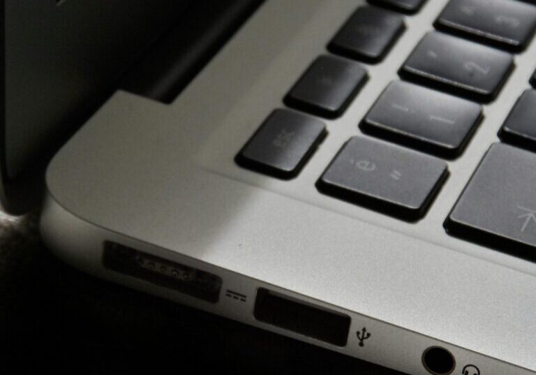 Free Detailed view of a silver laptop showing keyboard and multiple ports. Stock Photo