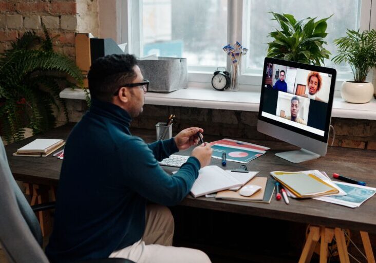 teacher-video-calling-with-his-students-using-a-computer